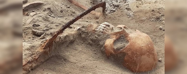 Human remains are found in Poland buried with a scythe